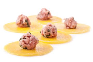 Half finished meat dumplings isolated on white background