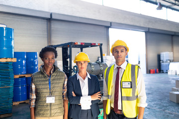 Warehouse staff looking at camera in warehouse