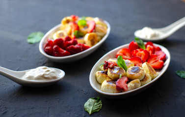 mini cheese pancakes with honey and strawberries on black background. proper nutrition healthy dessert