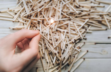 Man, girl sets fire to a large number of matches. Concept and photography. Fire safety. Options and choices, copy space, fire and danger.