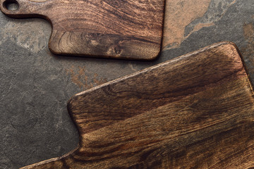 top view of brown wooden cutting boards on weathered grey background
