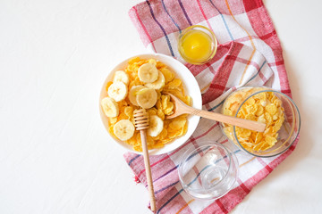 Traditional breakfast cereal of cornflakes and milk with a banana. Healthy lifestyle food.