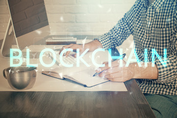 Blockchain theme hud with man working on computer on background. Concept of crypto chain. Double...