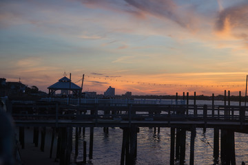 Fototapeta na wymiar Sunset on Long Beach, New York. Long beach at the evening. Summer weather