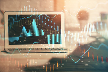 Double exposure of forex chart and work space with computer. Concept of international online trading.