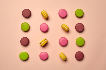 Colored macaron or macaroon, sweet meringue-based confection on pink background. Close-up, copy space.