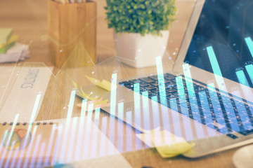 Double exposure of graph and financial info and work space with computer background. Concept of...