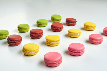 Colored macaron or macaroon, sweet meringue-based confection isolated on white. Close-up, copy space.