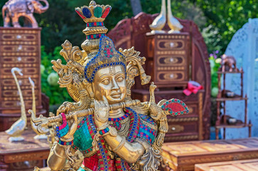 Fototapeta premium Hindu God Krishna. Statuette of Krishna playing the flute.