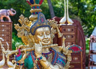 Hindu God Krishna. Statuette of Krishna playing the flute.