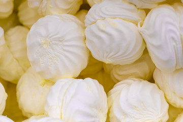Fototapeta na wymiar Bunch of lemon yellow delicious marshmallows closeup, selective focus.