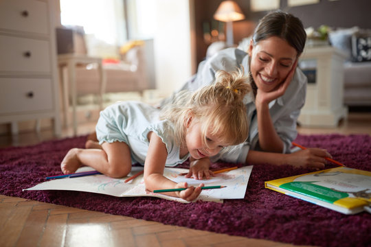 Adorable kid with female drawing indoor