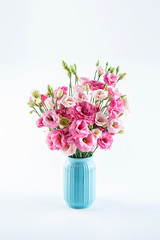 A beautiful bottle of eustoma flowers on a white background
