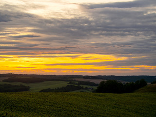 sunset over green field