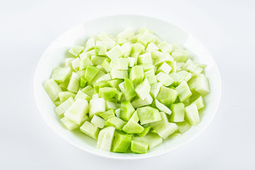 A dish of chopped diced cranberries on a white background