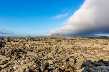 Old lava field on Iceland with in summer with cloudy sky