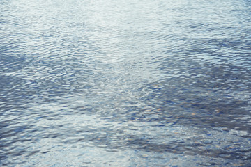 Obraz premium Shining blue wavy water surface ripple background