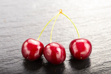 many sweet cherries on a black background