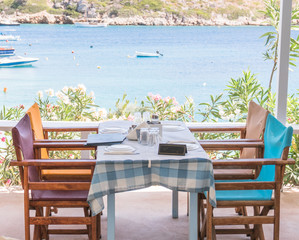beautiful terrace with table, chairs and blooming flowers with view of sea and mountains  Zakynthos Greece