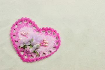 Heart-shaped lace ornament on canvas background