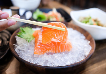 chopstick with hold salmon for eating 