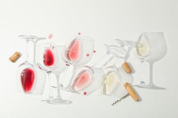 Flat lay composition. Corkscrew, glasses with different wine on white background