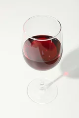Fotobehang Glass with red wine on white background, copy space © Atlas