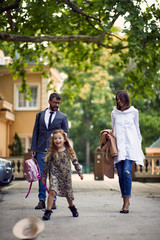 Fototapeta premium business parents walking with there daughter after school