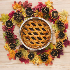 Top view autumn pie with wooden background