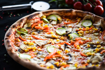 fresh italian pizza with vegetables - tomatoes, pumpkin, onion, corn & delicious cheese