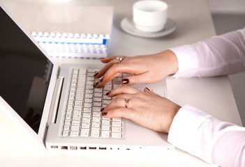 Young businesswoman working on a laptop in office