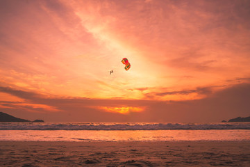 Sunset lovers, bright orange sky, on the beach Famous Phuket Patong Thailand
