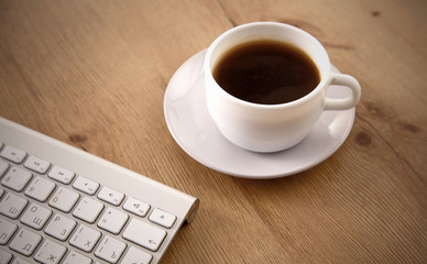 Office table with blank notepad and laptop