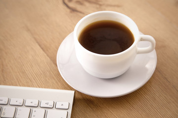 Office table with blank notepad and laptop