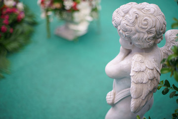 Cute Angel statue in the garden. Beautiful, thais, cupid