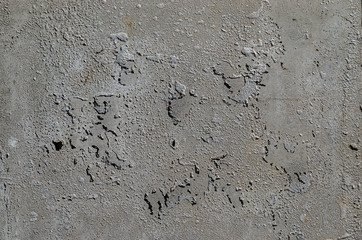 Urban concrete wall background with grooves and bubbles. Cement gray wall. Urban and industrialization art concept. Texture like concrete, stone, cement, plaster.. Poster mockup. Сloseup studio shot.