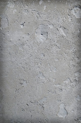Urban concrete wall background with grooves and bubbles. Cement gray wall. Urban and industrialization art concept. Texture like concrete, stone, cement, plaster.. Poster mockup. Сloseup studio shot.