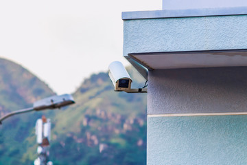 Outdoor surveillance camera on the corner of the house