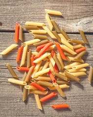 Raw homemade pasta and ingredients for pasta on wooden backgrou