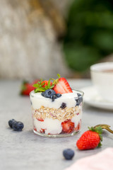 Greek yogurt with oatmeal and fresh berries in glass