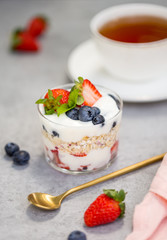 Granola with fresh berries and yogurt in glass