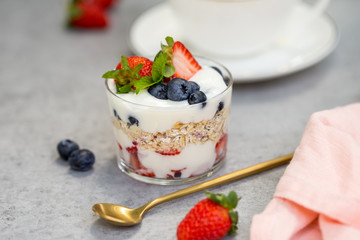 Oatmeal with yogurt and blueberries and strawberries in glass