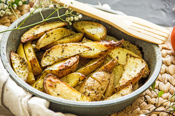 Homemade baked potato wedges with spices, copy space