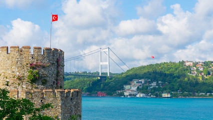 Fototapeta premium Rumelian Fortress and Bosphorus Bridge in İstanbul, Turkeyç Turquoise sea and cloud sky.