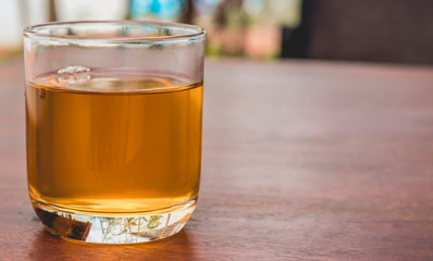 Transparent glass with tea on the table