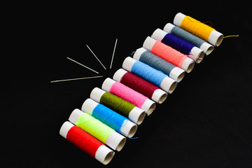 White coils paper with multi-colored threads isolated with background. Multi-color of threads for...