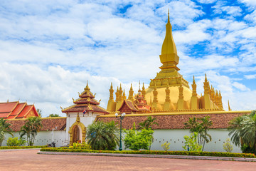 Vientiane Lao-July 6 2019 : Pha That Luang with blue sky background, Historical ancient golden pagoda religion place, View at front gate (editorial image)