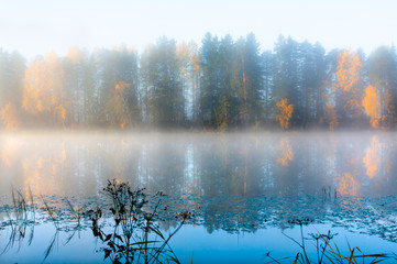 Naklejka na ściany i meble Beautiful autumn morning landscape of Kymijoki river waters in fog. Finland, Kymenlaakso, Kouvola.
