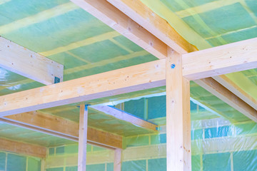 Bolting in a house with insulation. The ceiling in the cottage is covered with insulation. Finishing work in a wooden house. The construction of a cottage made of wood. Construction of private houses.