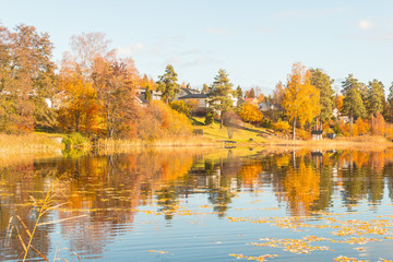Fototapeta na wymiar Autumn between villages, nature and water in Scandinavia